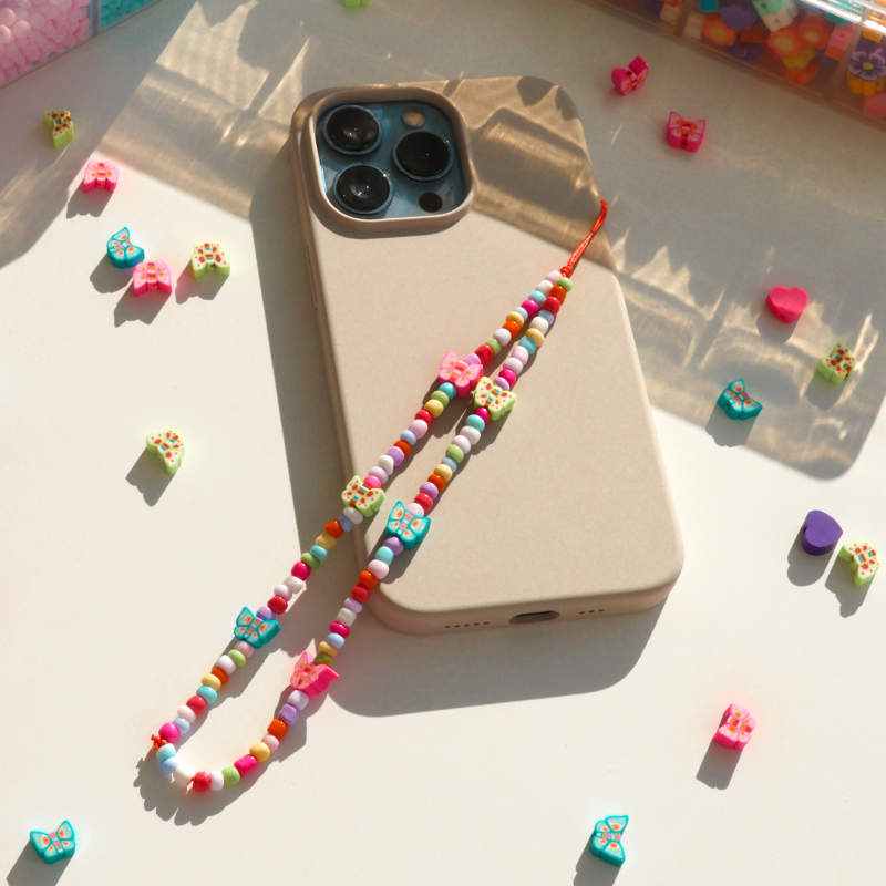 Butterflies dancing in a sun-kissed garden - Phone Charm
