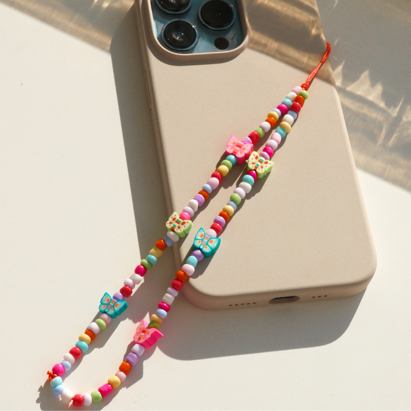 Butterflies dancing in a sun-kissed garden - Phone Charm