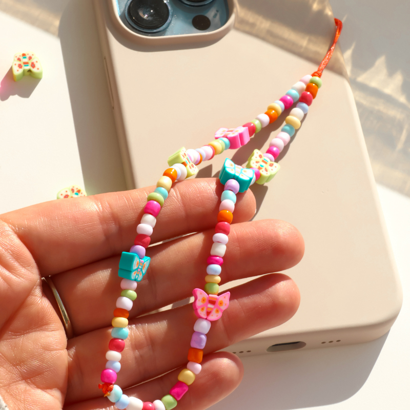 Butterflies dancing in a sun-kissed garden - Phone Charm