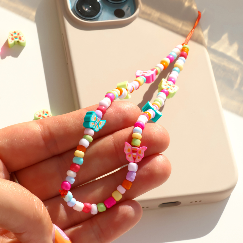 Butterflies dancing in a sun-kissed garden - Phone Charm